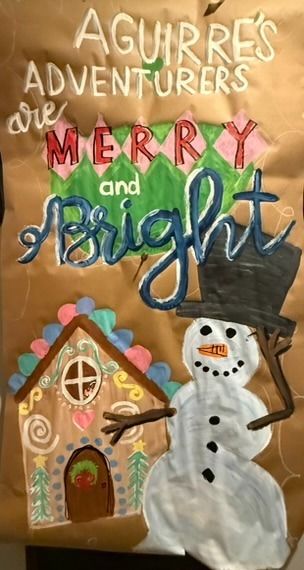 Hand-painted holiday birthday poster on kraft paper featuring a cheerful snowman with top hat, a gingerbread house with candy decorations, and 'Merry and Bright' lettering in festive red and green